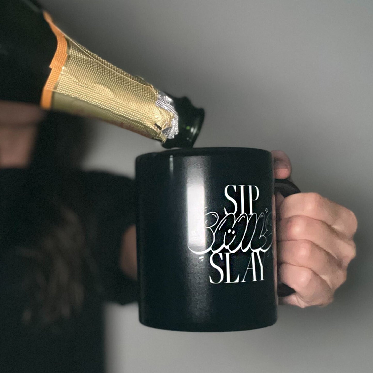 Black mug with the words "sip, smile, slay" on it